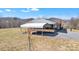 Ranch-style home with a covered carport and beautiful mountain views in the background at 6285 Nc 16 N Hwy, Taylorsville, NC 28681