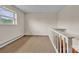 Neutral hallway with carpeted floor, open window, and wooden railings at 6285 Nc 16 N Hwy, Taylorsville, NC 28681