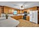 Well-lit kitchen features oak cabinets, a refrigerator with water dispenser, and practical flooring at 6285 Nc 16 N Hwy, Taylorsville, NC 28681