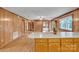 Open concept kitchen with wood paneling and view into other living spaces at 6285 Nc 16 N Hwy, Taylorsville, NC 28681