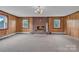 Living room features a brick fireplace, a large carpeted area, and windows on either side at 6285 Nc 16 N Hwy, Taylorsville, NC 28681