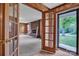 A view of the living room showcasing a brick fireplace and direct access to the front porch at 6285 Nc 16 N Hwy, Taylorsville, NC 28681