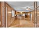 Open concept living space featuring wood paneled walls and an inviting kitchen bar area at 6285 Nc 16 N Hwy, Taylorsville, NC 28681