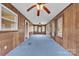 Bright sunroom with wood-paneled walls, carpet flooring, ceiling fans and many windows for natural light at 6285 Nc 16 N Hwy, Taylorsville, NC 28681