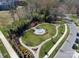 Aerial view of a neighborhood park with a fountain, walking paths, and lush landscaping at 6319 Hazelton Dr, Charlotte, NC 28210