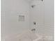 Sleek bathroom showcasing a soaking tub with white subway tile surround and stylish chrome fixtures at 6319 Hazelton Dr, Charlotte, NC 28210