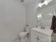 Modern bathroom featuring white subway tile, a sleek vanity, and contemporary fixtures for a clean aesthetic at 6319 Hazelton Dr, Charlotte, NC 28210