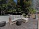 Outdoor patio featuring a wicker couch, pillows, and table, perfect for lounging and relaxing at 6319 Hazelton Dr, Charlotte, NC 28210