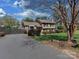 Two-story home featuring mature landscaping, a bay window, and a private driveway at 6319 Hazelton Dr, Charlotte, NC 28210