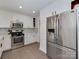 Bright kitchen with white cabinets, stainless steel appliances, and contemporary finishes for a modern culinary experience at 6319 Hazelton Dr, Charlotte, NC 28210