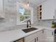 Bright kitchen features white cabinets, stainless steel sink, and marble backsplash at 6319 Hazelton Dr, Charlotte, NC 28210