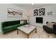 Stylish living room with a green velvet sofa, modern art, and a cozy fireplace, perfect for entertaining at 6319 Hazelton Dr, Charlotte, NC 28210