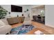 Stylish living room area showcasing modern furniture, a large TV, and seamless flow to the dining space at 6319 Hazelton Dr, Charlotte, NC 28210