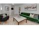 Comfortable living room featuring a plush green sofa, stylish decor, and an open layout to the stairs at 6319 Hazelton Dr, Charlotte, NC 28210