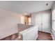 Upstairs hallway featuring hardwood floors, closet doors, with natural light through window at 6636 Rustic View Ct, Charlotte, NC 28216