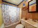 A compact bathroom setup with standard fixtures and a privacy curtain at 701 N Scruggs St, Gastonia, NC 28052