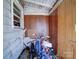 View of covered storage area with wood paneling and bikes at 701 N Scruggs St, Gastonia, NC 28052