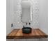 Elegant bathroom featuring unique patterned tiles and wood countertop with modern fixtures at 715 N Church St, Charlotte, NC 28202