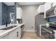 Bright kitchen with white cabinets, stainless steel appliances, and a view into the adjacent living spaces at 715 N Church St, Charlotte, NC 28202