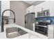 Modern kitchen features stainless steel appliances and a breakfast bar with quartz countertop at 715 N Church St, Charlotte, NC 28202