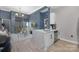 Open-concept kitchen with stainless appliances, quartz countertops, and views into the living area and balcony at 715 N Church St, Charlotte, NC 28202