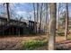 Home exterior with upper deck in a wooded lot with mature trees and lush foliage at 810 Bridgewood Dr, Rock Hill, SC 29732