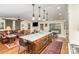 Open-concept kitchen with island, flowing into the living area with fireplace and built-in shelving at 810 Bridgewood Dr, Rock Hill, SC 29732