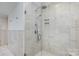 Modern shower boasting marble-look tiles, glass doors, and updated fixtures at 810 Bridgewood Dr, Rock Hill, SC 29732