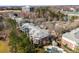 Aerial view of a condo community with multiple buildings, a pool, parking lots, and mature trees at 921 Northeast Dr # 26, Davidson, NC 28036