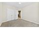 Neutral bedroom featuring a double door closet, carpeted floors, and a view to the hall at 921 Northeast Dr # 26, Davidson, NC 28036