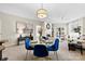 Open-concept dining area with stylish light fixture, adjacent to living area and a fireplace, offers comfortable living at 921 Northeast Dr # 26, Davidson, NC 28036