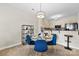 Cozy dining area next to the kitchen features a glass table, blue chairs, and a stylish light fixture at 921 Northeast Dr # 26, Davidson, NC 28036