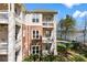 Lakefront condo featuring balconies, brick accents, and lush landscaping with beautiful lake views at 921 Northeast Dr # 26, Davidson, NC 28036