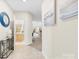 Hallway with access to a bathroom and a glimpse of the dining and living area at 921 Northeast Dr # 26, Davidson, NC 28036