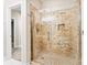 A tiled shower stall with a glass door and shower head, with a partial view of the bathroom at 921 Northeast Dr # 26, Davidson, NC 28036