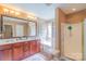 This bathroom has a double sink vanity, a soaking tub and separate shower at 10406 Little Whiteoak Rd, Charlotte, NC 28215