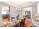 Bright dining room with a glass-top table and a view into the living room, creating an open and inviting space at 10406 Little Whiteoak Rd, Charlotte, NC 28215