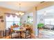 Bright dining area featuring a round table, natural lighting, and an open view into the adjacent sunroom at 10406 Little Whiteoak Rd, Charlotte, NC 28215