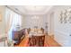 Elegant dining room featuring a glass-top table, chandelier, and wainscoting, perfect for formal gatherings at 10406 Little Whiteoak Rd, Charlotte, NC 28215