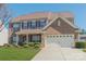 Beautiful brick home with an attached two-car garage, showcasing a lush green lawn and manicured landscaping at 10406 Little Whiteoak Rd, Charlotte, NC 28215