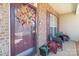 Close-up of a welcoming front porch featuring a festive wreath, comfortable seating, and charming decor elements at 10406 Little Whiteoak Rd, Charlotte, NC 28215