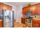 Open kitchen features stainless steel appliances and dark wood cabinets at 10406 Little Whiteoak Rd, Charlotte, NC 28215