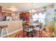 Eat-in kitchen features wooden cabinetry, modern lighting, and a circular dining table at 10406 Little Whiteoak Rd, Charlotte, NC 28215