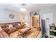 Comfortable living room with a brown sectional sofa, a wooden coffee table, and neutral walls at 10406 Little Whiteoak Rd, Charlotte, NC 28215