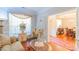 Bright living room showcasing elegant decor, a large window, and French doors leading to a formal dining area at 10406 Little Whiteoak Rd, Charlotte, NC 28215