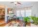 Bright sun room with hardwood floors, a ceiling fan, and two lounge chairs at 10406 Little Whiteoak Rd, Charlotte, NC 28215