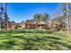 A large, fenced yard surrounds the brick home and detached garage, perfect for pets and outdoor activities at 106 Wolf Hill Dr, Mooresville, NC 28117