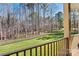 Beautiful backyard view from the deck showcases a green lawn and a fenced perimeter, creating a private outdoor space at 106 Wolf Hill Dr, Mooresville, NC 28117