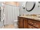 Bathroom featuring a shower with curtain, granite countertop, and warm wood cabinets at 106 Wolf Hill Dr, Mooresville, NC 28117