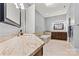 Bright bathroom with a granite-topped vanity and tile flooring offers a skylight at 106 Wolf Hill Dr, Mooresville, NC 28117